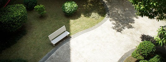 Outdoor school courtyard with benches and walking path 