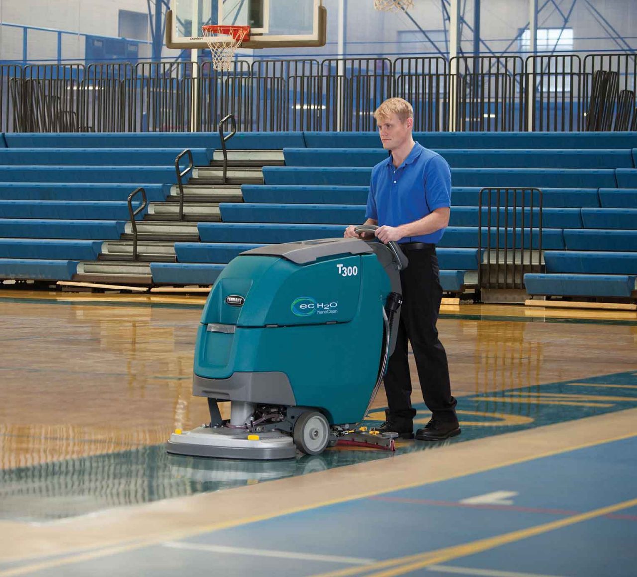 Tennant T300 Walk-Behind Scrubber cleaning a gym